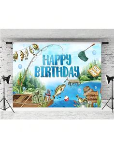 an image of a happy birthday banner with fish and fishing items in the water on a white brick wall