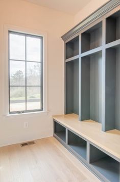 the empty room is clean and ready to be used as a storage area for books