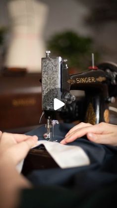 a woman is using a sewing machine to sew something