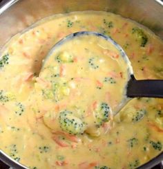 broccoli and cheese soup in a pot with a ladle