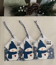 three tags with snowmen hanging from them