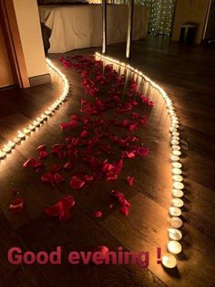 rose petals on the floor next to candles