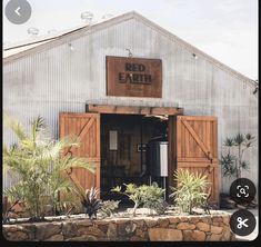 an image of a red earth winery in the middle of palm trees and other plants