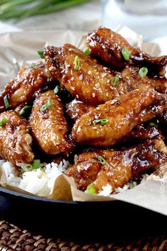 chicken wings with sesame seeds on top of rice