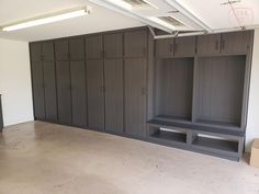 an empty room with several large wooden cabinets