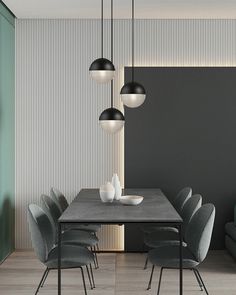 a modern dining room with grey chairs and a gray table surrounded by black wallpaper