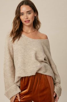 So chic and effortless, this slouchy, oversized tunic-style sweater features a v-neckline and dropped wide sleeves for added shape. -Available in Stone & Misty Blue -Waffle textured -V-neck -Oversized fit -Soft touch eyelash two tone yarn -Long sleeve with folded cuffs -Side slits -Ribbed on hem -Content: 74% Acrylic 22% Polyester 4% Lycra -Hand was cold/Line dry -Imported -Model is 5 8" 32-24-34 and wearing a size Small Oversized V-neck Sweater For Layering, Oversized Chic V-neck Sweater For Layering, Chic Oversized V-neck Sweater For Layering, Oversized V-neck Chic Sweater, Oversized V-neck Sweater For Loungewear, Oversized Chic V-neck Sweater, Oversized Soft Knit V-neck Sweater For Fall, Oversized V-neck Sweater For Fall, Chic Oversized V-neck Sweater For Loungewear