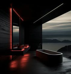 a bath tub sitting next to a large window in a room with dark walls and flooring