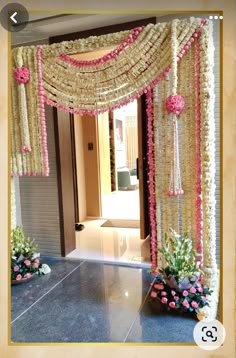 an entrance decorated with pink and white flowers