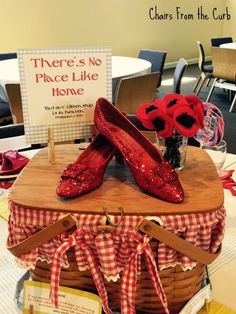 red shoes sitting on top of a basket with a sign in front of it that says there's no place like home