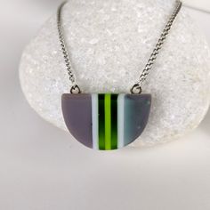 One of a kind handmade fused glass pendant. Simple and elegant modern minimalist style Transparent green gray and with stripes with geometric shape. Size: 30mm x 20mm x 6mm. Cast silver necklace attachments. Incorporates Bullseye opal and transparent glass. Sculpted by hand and fused multiple times. Includes nickle free hypoallergenic 18 inch attached chain. Message anytime with questions. -Sean Modern Green Necklace As Gift, Modern Green Necklace For Gift, Modern Green Necklace As A Gift, Modern Green Necklace With Round Pendant, Modern Green Round Pendant Necklace, Minimalist Green Jewelry With Recycled Glass, Minimalist Green Glass Jewelry, Modern Silver Glass Necklaces, Modern Green Geometric Jewelry