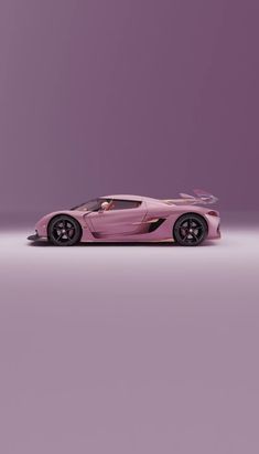 a pink sports car parked in front of a purple wall