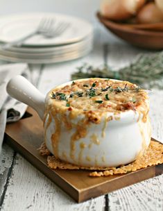 a bowl of food sitting on top of a cutting board