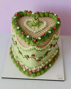 a heart shaped cake on top of a card board