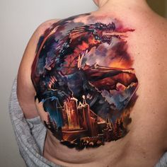 the back of a man's shoulder with an image of a dragon on it