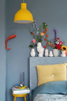 a bedroom with blue walls and yellow accents