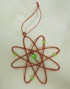 an image of a science ornament made out of wire and beads on a white background