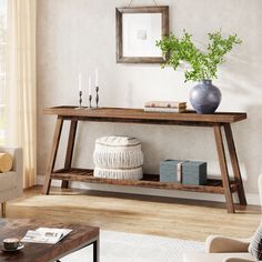 a living room with a couch, coffee table and potted plant on the shelf