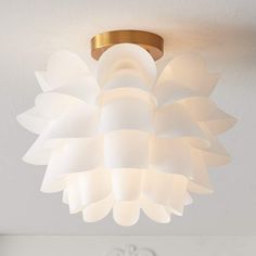 a white light fixture hanging from the ceiling