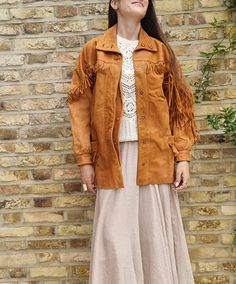 Amazing true vintage leather jacket in golden tan brown with long leather tassels. This is an authentic 1960s or 1970s fringe leather jacket in size small UK 8-10 (true to size!). The jacket has a Native American hippie style and has long leather tassels on the arms, front and back. This Navajo jacket is a women's jacket ideal for autumn, spring, festivals and going out. Made in Britain  Size is S, UK8-10 length: 77cm = 30" bust (armpit to armpit): 55 cm = 21.5" Please note that this is a true vintage jacket but it's still in excellent condition. There's only a small damage on the collar. See pictures ;) 🧼 Care Recommendations: Maintain the vintage charm of this bag by applying leather conditioner occasionally and protecting it from excessive moisture. 🌟 Leather Disclaimer: There may be Leather Jacket For Fall Festival, Brown Tasseled Outerwear For Spring, Bohemian Long-sleeve Leather Jacket For Fall, Bohemian Long Sleeve Leather Jacket For Fall, Leather Tassel Outerwear For Fall, Fall Leather Tassel Outerwear, Fall Festival Long Sleeve Leather Jacket, Long Sleeve Leather Jacket For Fall Festivals, Fall Festival Leather Jacket