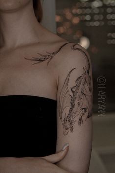 a woman with a dragon tattoo on her arm