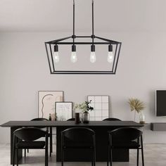 a dining room table with chairs and a black chandelier hanging from the ceiling