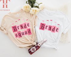 two t - shirts with the words babe, bride and baby on them next to flowers