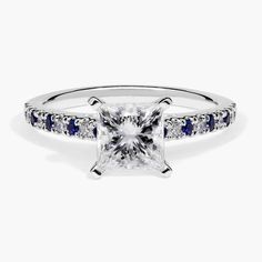 a princess cut diamond ring with blue sapphire stones