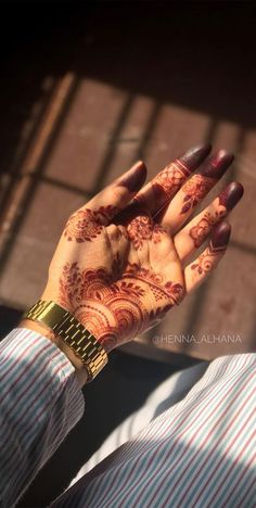 a woman's hand with henna on it