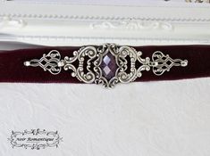 ♥♥Noir Romantique♥♥ Welcome to my store! --------Countess Erzebet's choker----------- This beautiful and elegant choker is made of burgundy red fine velvet ribbon,embelished with beautiful silver rococo connectors harmonically combined to give an elegand and dramatic result. Purple gem 13x18mm is nestled within a silver rectangle setting .It fastens with silver chain and clasp.All components are silver plated made in America always of highest quality. ♥♥ If you need a specific length please let Victorian Adjustable Choker For Formal Occasions, Victorian Style Adjustable Choker For Formal Occasions, Adjustable Victorian Choker For Formal Occasions, Gothic Choker For Formal Occasions, Gothic Adjustable Choker For Formal Occasions, Adjustable Gothic Choker For Formal Occasions, Elegant Choker, Gothic Chokers, Purple Gems