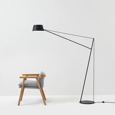 a black floor lamp next to a gray chair