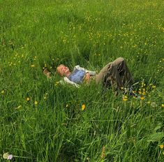 a man laying in the middle of a field