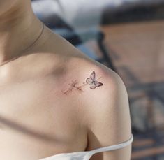 a woman with a butterfly tattoo on her shoulder