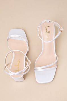 Any luxe look deserves a fabulous finish, which is why you'll always reach for the Lulus Loxley White Satin Ankle Strap High Heel Sandals to complete the 'fit! Luxurious woven satin shapes these too-chic heels that feature a square toe bed, slender asymmetrical toe straps, and matching straps that sprout from the sides to wrap and secure around the ankle with a gold buckle. A stylish blade heel adds an extra-trendy touch to this sleek design! 2. 75" wrapped blade heel. Cushioned insole. Rubber s Short Sandal Heels, White Gold Heels, White And Gold Heels, Chic Heels, Ankle Strap High Heels, Size 11 Heels, Sandal Heels, Gold Heels, Heel Sandal