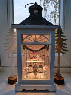 a doll house is lit up in the window