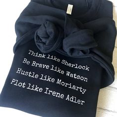 a black t - shirt with white writing on it that says think like sherlook be brave like watson hustle like monetary plot like trene adler