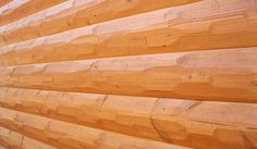 the side of a house with wood siding on it's sides and a window