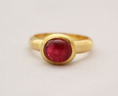 ♦♦ Beautiful handcrafted ring ◘Stone Information: Genuine Burmese Spinel (Natural No Heat) Color: Red Cut: Oval Cabochon Size: 8 mm ◘ Metal: 925 Sterling Silver ◘ Band: 5 mm Textured ◘ Setting: Open back bezel setting ◘ Finish: Textured ◘ Nickel free ◘ Anti tarnish ◘ Vermeil Gold(Optional) ◘ Handmade band: 14 gauge solid sterling wire This ring is adorably rustic, easy to wear, & stackable! ◘Please Note - The Ring in the Picture can be available or Sold out. Every Ring is Made of a Unique Ge Red Domed Gemstone Rings, Domed Ruby Gemstone Jewelry, Oval Cabochon Ruby Gemstones, Ruby Jewelry With Large Round Stone, Round Ruby Jewelry With Large Stone, Oval Cabochon Ruby Jewelry With Bezel Setting, Elegant Large Stone Ruby Ring, Classic Round Ruby Ring With Stone Setting, Oval Cabochon Ruby Gemstone Jewelry