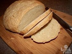 a loaf of bread sitting on top of a cutting board next to a knife