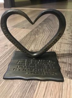 a heart shaped sculpture on top of a wooden table