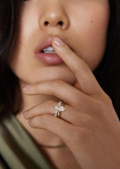 a close up of a person with a ring on her finger