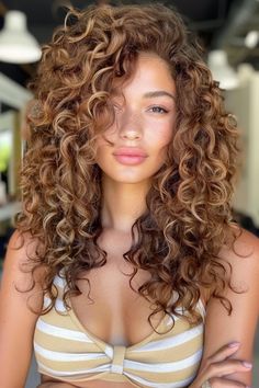 A person with curly hair wearing a striped bikini top. Curly Hair Color For Brown Skin, Curly Hair Color Ideas Balayage Caramel, Honey Brown Hair Curly Highlights, Caramel Brown With Highlights, Light Honey Brown Hair Curly, Brown Red Hair With Blonde Highlights, Honey Brown Balayage Hair, Brown Hair With Warm Blonde Highlights, Caramel Lowlights On Brown Hair