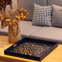 a living room with a couch, coffee table and flower arrangement