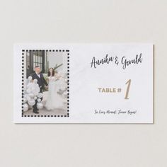 a table number card with an image of a bride and groom in formal attire on it