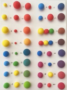 an array of colorful balls and numbers on a white surface with one missing the middle