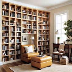 a living room filled with lots of bookshelves next to a chair and table