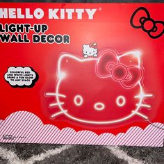 the hello kitty light up wall decor is on display in front of a red background