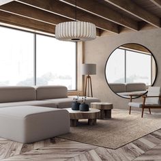 a modern living room with large windows and wood flooring, along with a round mirror on the wall