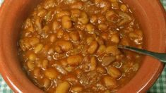 a bowl filled with beans sitting on top of a table