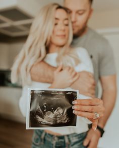 a man and woman holding up an x - ray image